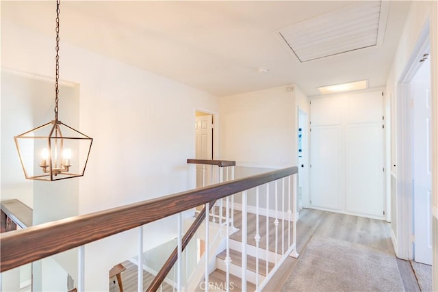 24046 Lindley St, Mission Viejo, CA 92691 - hall featuring light wood-type flooring, an upstairs landing, and a chandelier