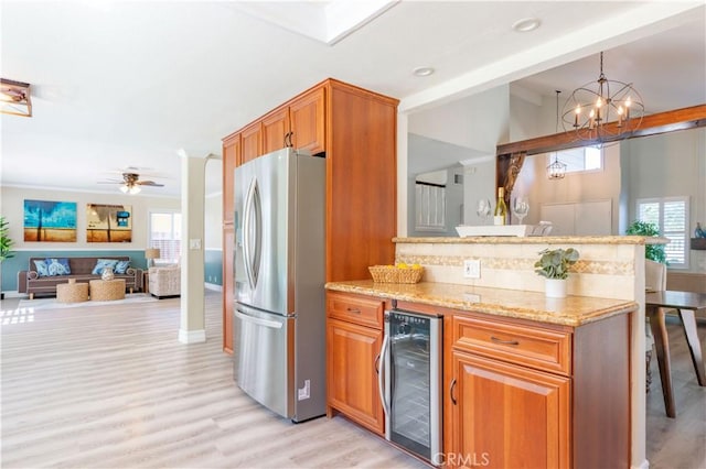 24046 Lindley St, Mission Viejo, CA 92691 - kitchen featuring freestanding refrigerator, wine cooler, open floor plan, light wood-type flooring, and light stone counters