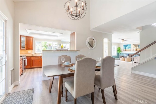 24046 Lindley St, Mission Viejo, CA 92691 - dining area with light wood-style floors, ceiling fan, arched walkways, and stairway