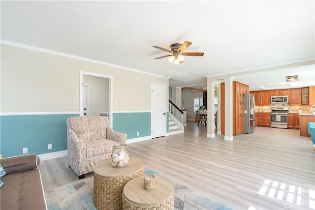 24046 Lindley St, Mission Viejo, CA 92691 - living area with crown molding, stairs, light wood-style flooring, and ceiling fan
