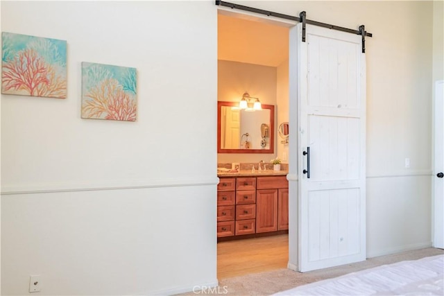 24046 Lindley St, Mission Viejo, CA 92691 - bedroom featuring a barn door and connected bathroom