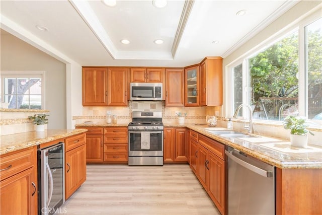 24046 Lindley St, Mission Viejo, CA 92691 - kitchen with stainless steel appliances, wine cooler, healthy amount of natural light, a raised ceiling, and ornamental molding