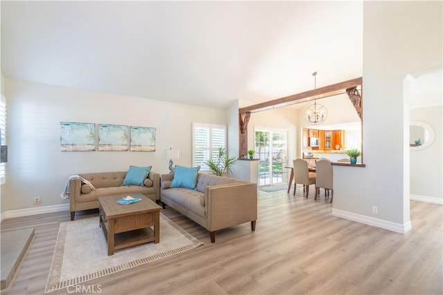 24046 Lindley St, Mission Viejo, CA 92691 - living area featuring a chandelier, light wood-style floors, and lofted ceiling