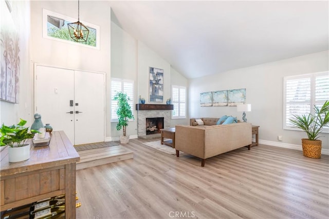 24046 Lindley St, Mission Viejo, CA 92691 - living room with high vaulted ceiling, light wood-style flooring, and a fireplace