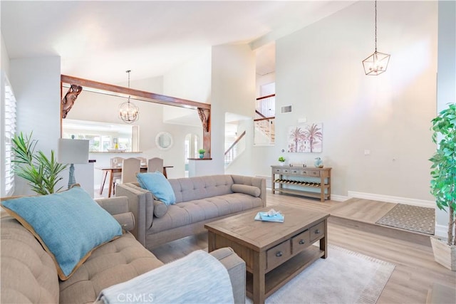 24046 Lindley St, Mission Viejo, CA 92691 - living area featuring a chandelier, wood finished floors, stairway, and high vaulted ceiling