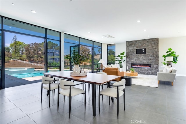 1912 Edgefair Ln, Redlands, CA 92373 - dining area featuring a stone fireplace, expansive windows, and recessed lighting