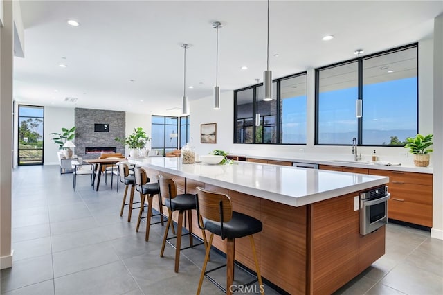 1912 Edgefair Ln, Redlands, CA 92373 - kitchen with modern cabinets, stainless steel oven, brown cabinets, a large island, and light countertops