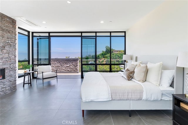1912 Edgefair Ln, Redlands, CA 92373 - tiled bedroom featuring floor to ceiling windows and a stone fireplace