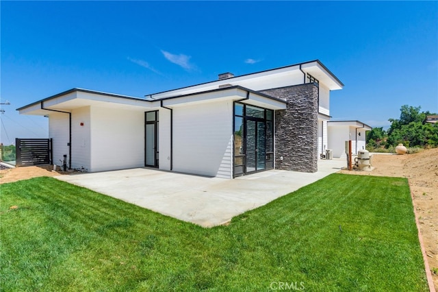 1912 Edgefair Ln, Redlands, CA 92373 - rear view of house featuring a patio, stone siding, a yard, and a chimney