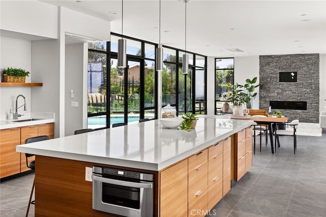 1912 Edgefair Ln, Redlands, CA 92373 - kitchen with modern cabinets, open shelves, light countertops, open floor plan, and floor to ceiling windows