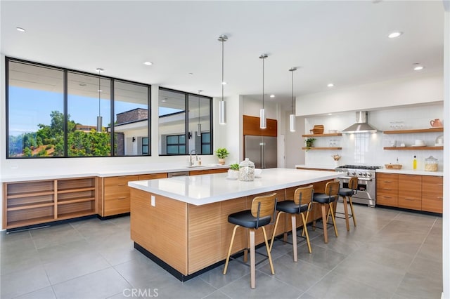 1912 Edgefair Ln, Redlands, CA 92373 - kitchen featuring high end appliances, open shelves, wall chimney range hood, modern cabinets, and decorative backsplash