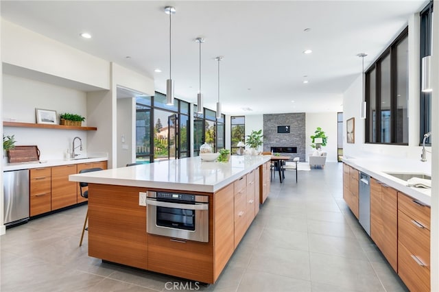 1912 Edgefair Ln, Redlands, CA 92373 - kitchen with modern cabinets, appliances with stainless steel finishes, a fireplace, and recessed lighting