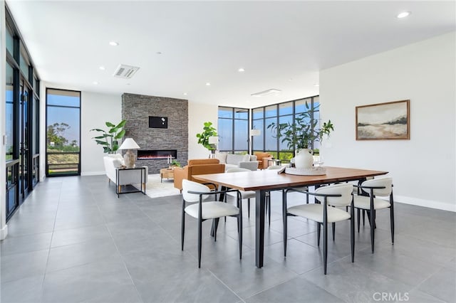 1912 Edgefair Ln, Redlands, CA 92373 - dining room featuring a wall of windows, a stone fireplace, recessed lighting, and tile patterned flooring