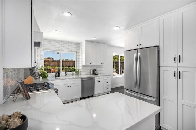 24532 La Cienega St, Laguna Hills, CA 92653 - kitchen featuring stainless steel appliances, white cabinets, backsplash, recessed lighting, and light stone countertops