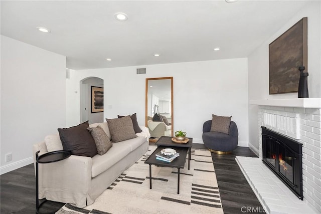 24532 La Cienega St, Laguna Hills, CA 92653 - living area with wood finished floors, a brick fireplace, recessed lighting, and arched walkways