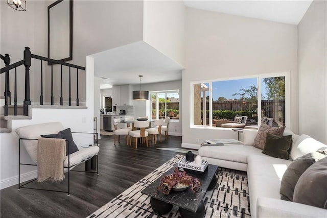 24532 La Cienega St, Laguna Hills, CA 92653 - living room featuring a high ceiling, dark wood-style floors, and stairs