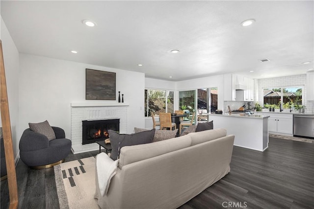 24532 La Cienega St, Laguna Hills, CA 92653 - living room featuring recessed lighting, dark wood finished floors, and a fireplace