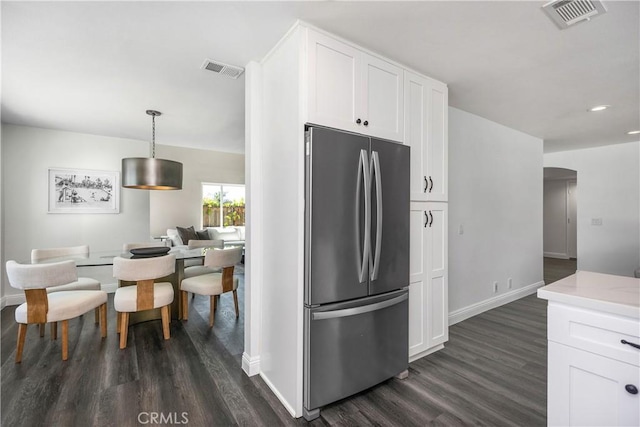24532 La Cienega St, Laguna Hills, CA 92653 - kitchen featuring freestanding refrigerator, dark wood-style floors, white cabinetry, arched walkways, and recessed lighting