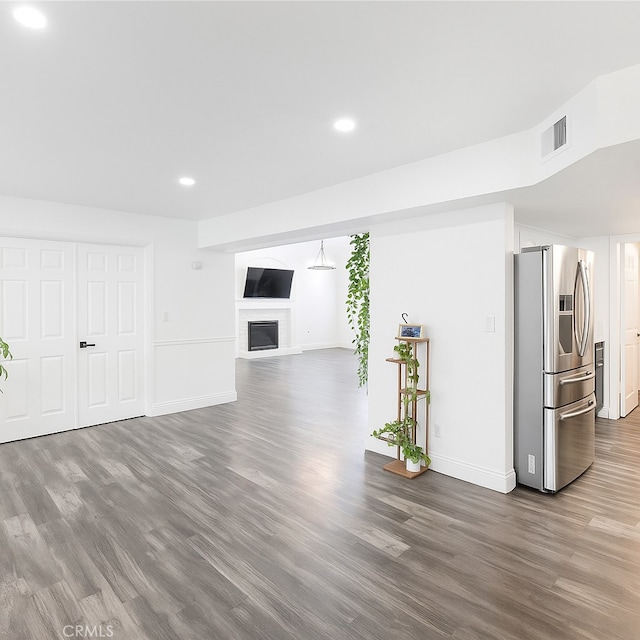 14016 Las Entradas, Bakersfield, CA 93314 - unfurnished living room featuring wood finished floors, recessed lighting, and a fireplace