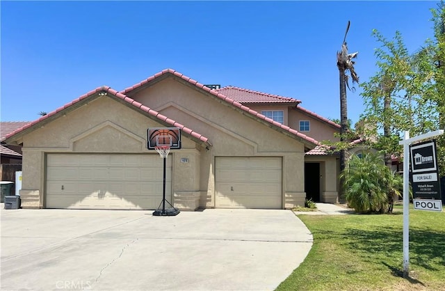 14016 Las Entradas, Bakersfield, CA 93314 - mediterranean / spanish-style home featuring concrete driveway, a garage, stucco siding, and a tile roof