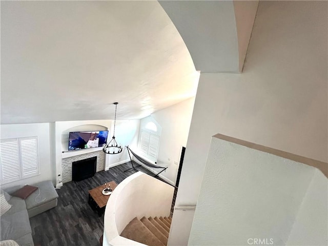 14016 Las Entradas, Bakersfield, CA 93314 - living area with a tiled fireplace, wood finished floors, vaulted ceiling, and plenty of natural light