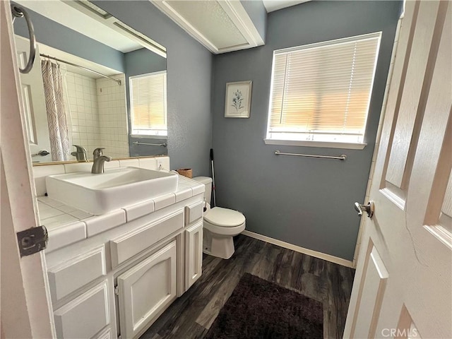 14016 Las Entradas, Bakersfield, CA 93314 - full bath featuring wood finished floors, vanity, healthy amount of natural light, and curtained shower