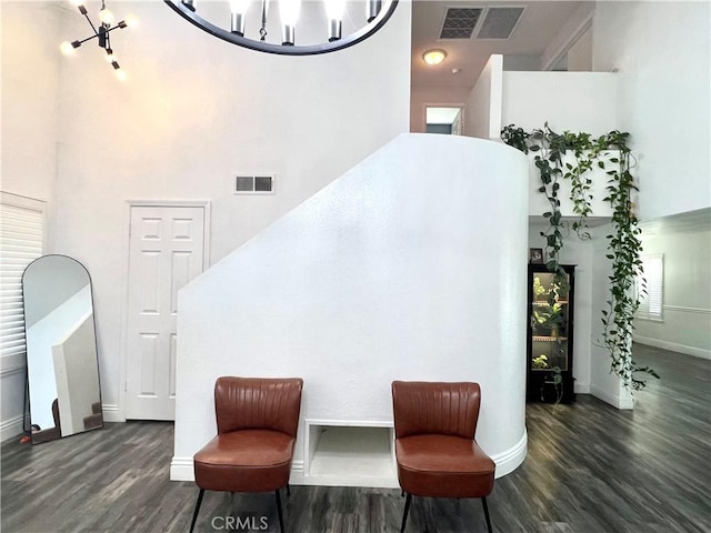 14016 Las Entradas, Bakersfield, CA 93314 - sitting room with wood finished floors, a towering ceiling, and a chandelier