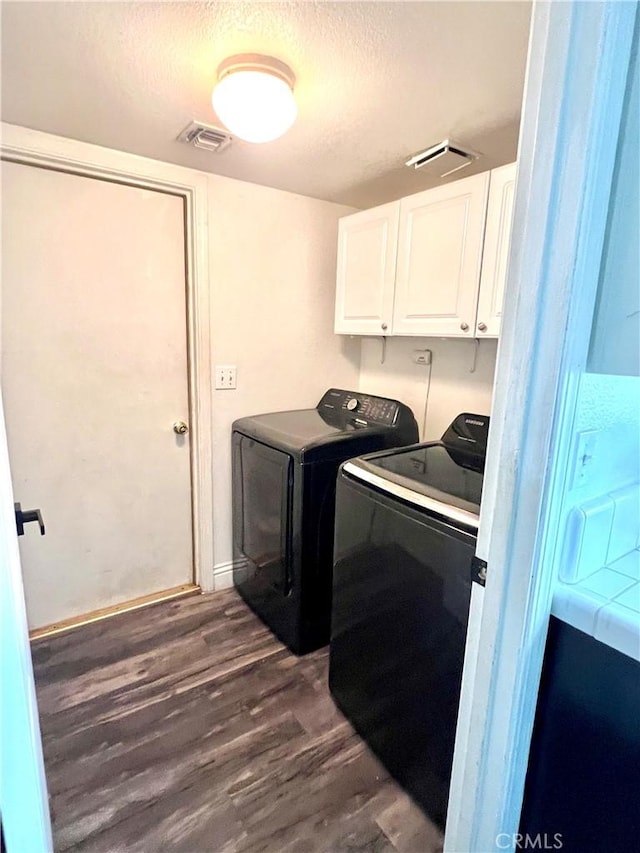 14016 Las Entradas, Bakersfield, CA 93314 - laundry area featuring cabinet space, washer and dryer, a textured ceiling, and dark wood-style flooring