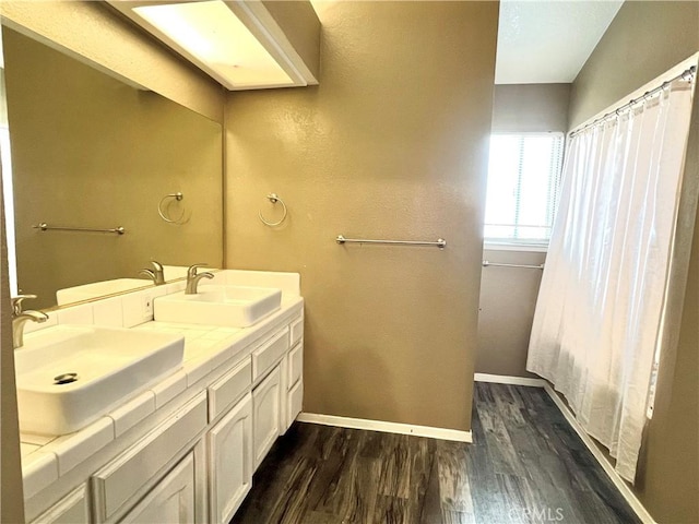 14016 Las Entradas, Bakersfield, CA 93314 - bathroom featuring wood finished floors and double vanity