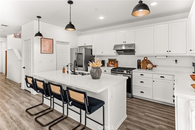 872 Bluebell Way, Beaumont, CA 92223 - kitchen featuring appliances with stainless steel finishes, white cabinetry, light countertops, dark wood finished floors, and recessed lighting