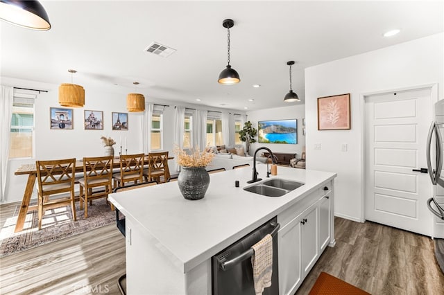 872 Bluebell Way, Beaumont, CA 92223 - kitchen with stainless steel dishwasher, wood finished floors, light countertops, a center island with sink, and recessed lighting