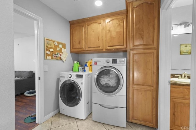 2164 Bluehaven Ct, San Diego, CA 92154 - laundry room featuring washer and dryer, cabinet space, and light tile patterned flooring