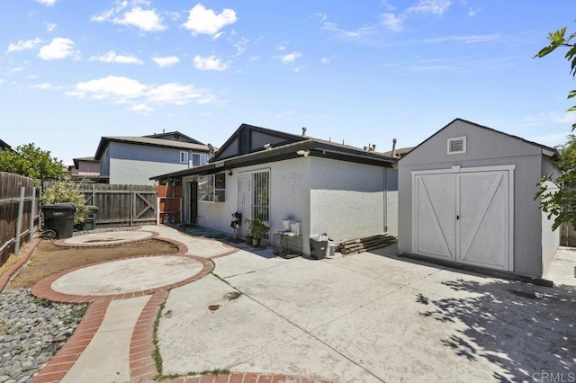 2164 Bluehaven Ct, San Diego, CA 92154 - rear view of house with a patio area, a storage shed, stucco siding, and a gate