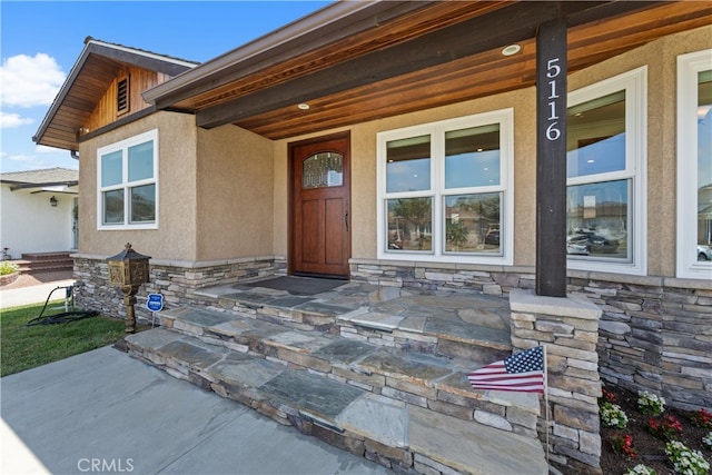 5116 Faust Ave, Lakewood, CA 90713 - view of exterior entry with stone siding, a porch, and stucco siding
