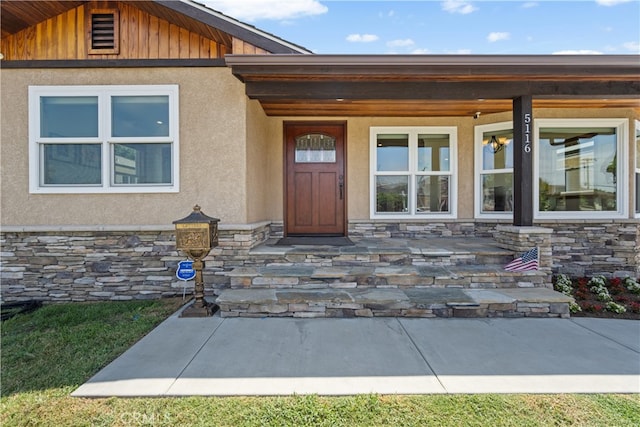 5116 Faust Ave, Lakewood, CA 90713 - doorway to property with stone siding, stucco siding, and covered porch