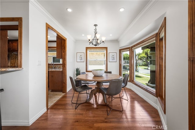 5116 Faust Ave, Lakewood, CA 90713 - dining space featuring a chandelier, dark wood-style flooring, recessed lighting, and crown molding