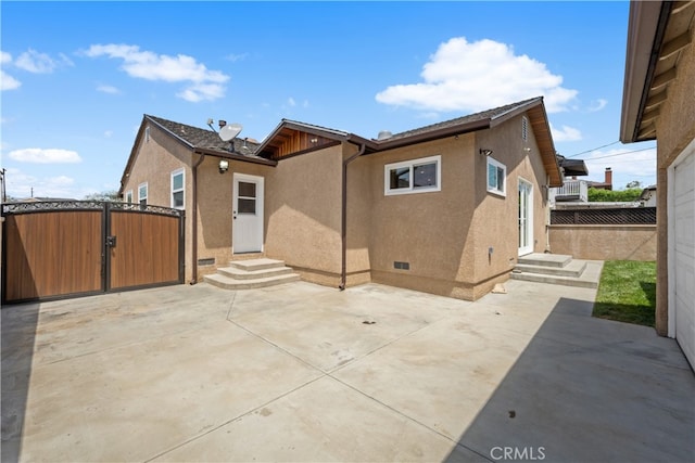 5116 Faust Ave, Lakewood, CA 90713 - rear view of house featuring a gate, stucco siding, entry steps, and a patio area