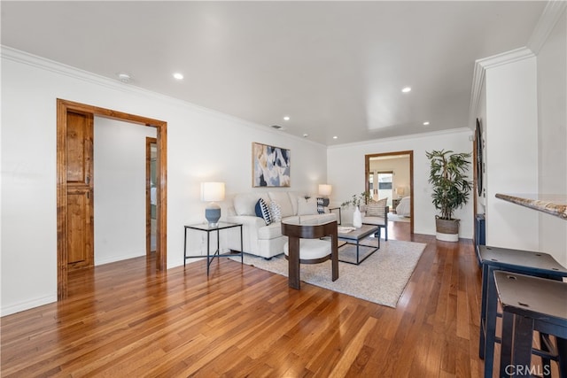 5116 Faust Ave, Lakewood, CA 90713 - living room featuring light wood finished floors, recessed lighting, and ornamental molding