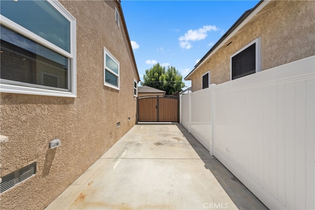 5116 Faust Ave, Lakewood, CA 90713 - view of property exterior featuring stucco siding, a gate, and a patio