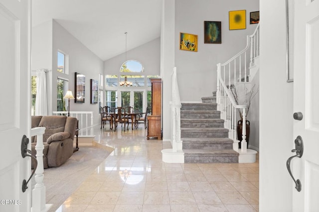 2106 Fox Den Ct, Oxnard, CA 93036 - foyer featuring stairway, high vaulted ceiling, a chandelier, and light marble finish floors