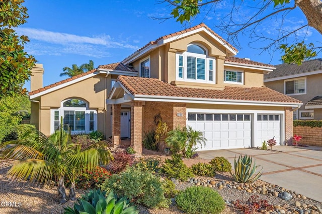 2106 Fox Den Ct, Oxnard, CA 93036 - view of front of home with driveway, brick siding, a garage, and a tile roof