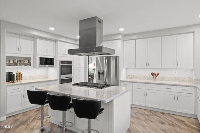 2106 Fox Den Ct, Oxnard, CA 93036 - kitchen with island exhaust hood, stainless steel appliances, recessed lighting, a kitchen island, and light wood-style flooring