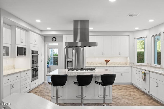 2106 Fox Den Ct, Oxnard, CA 93036 - kitchen with wall chimney exhaust hood, healthy amount of natural light, recessed lighting, appliances with stainless steel finishes, and light wood-type flooring