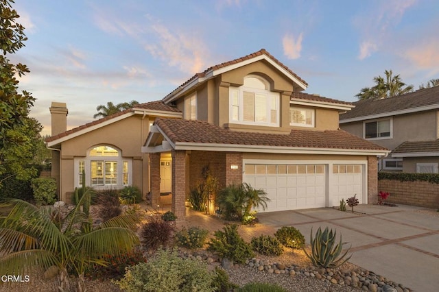 2106 Fox Den Ct, Oxnard, CA 93036 - traditional home with driveway, an attached garage, a chimney, brick siding, and a tile roof