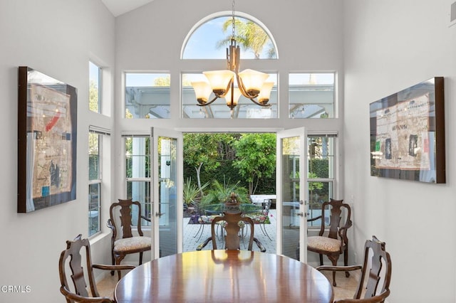 2106 Fox Den Ct, Oxnard, CA 93036 - dining room with french doors, a high ceiling, and a chandelier