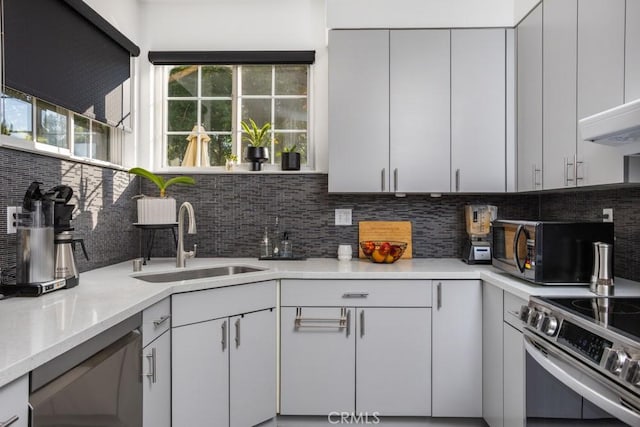 17 Carnegie, San Jose, CA 95116 - kitchen featuring black microwave, stainless steel electric stove, tasteful backsplash, and light countertops