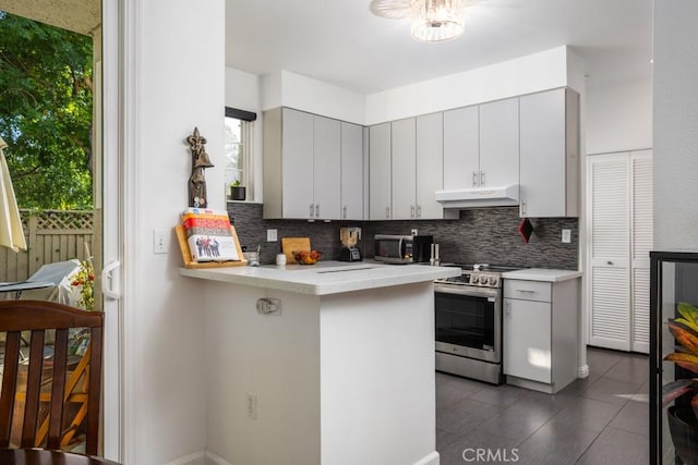17 Carnegie, San Jose, CA 95116 - kitchen with stainless steel appliances, tasteful backsplash, light countertops, under cabinet range hood, and a peninsula
