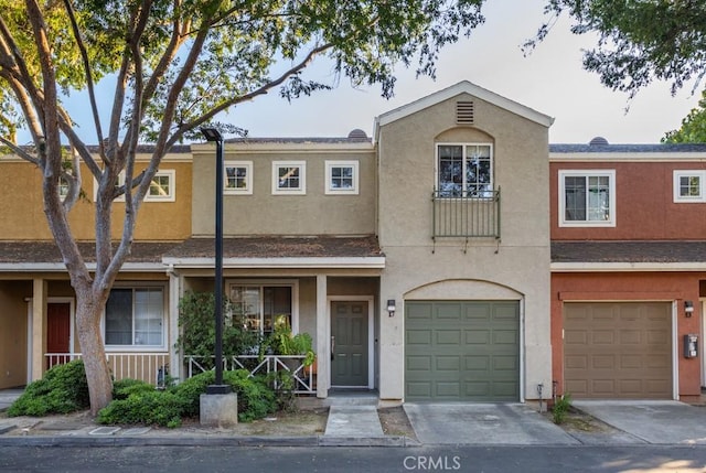 17 Carnegie, San Jose, CA 95116 - view of front facade featuring a garage, driveway, and stucco siding