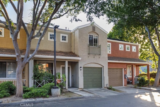 17 Carnegie, San Jose, CA 95116 - view of front of home featuring a garage, driveway, stucco siding, and covered porch