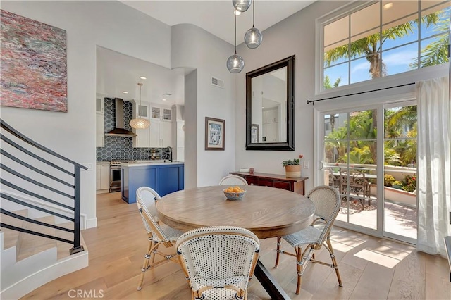 19325 Peachtree Ln, Huntington Beach, CA 92648 - dining space featuring stairs, light wood finished floors, and a high ceiling
